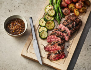 Grilled hanger steaks with shallot, maple and brown beer sauce, and grilled vegetables